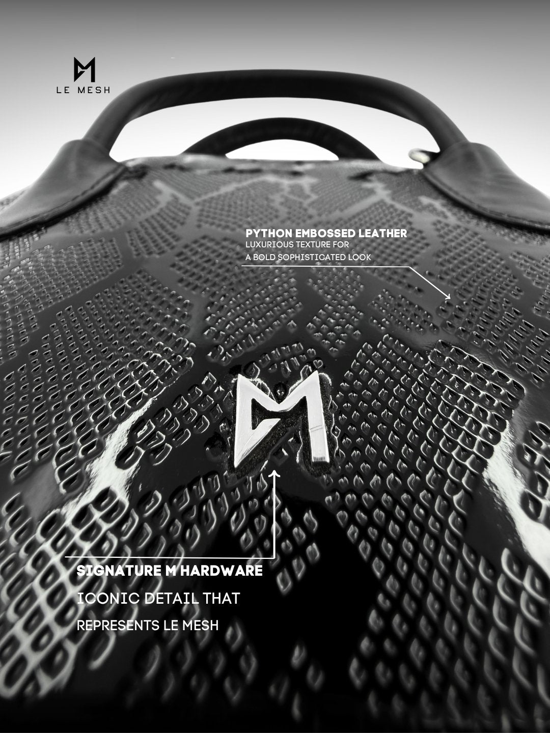 Black textured leather bag with 'M' logo and brand name 'Le Mesh' on a gray background
