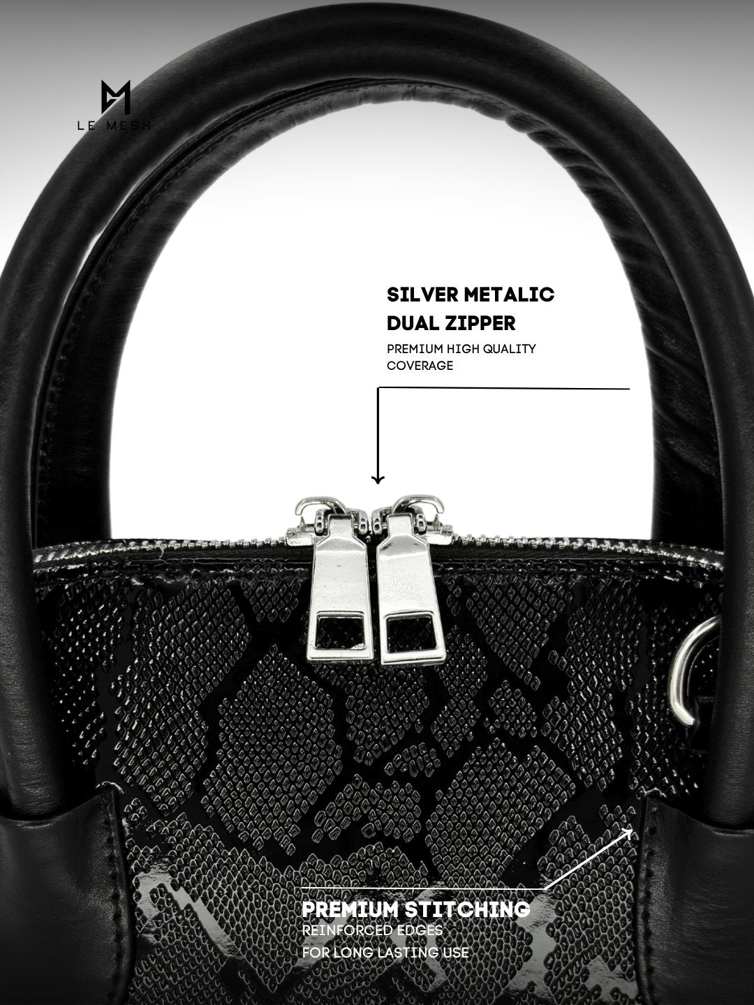 Black handbag with silver metallic dual zipper and premium stitching details on a white background.