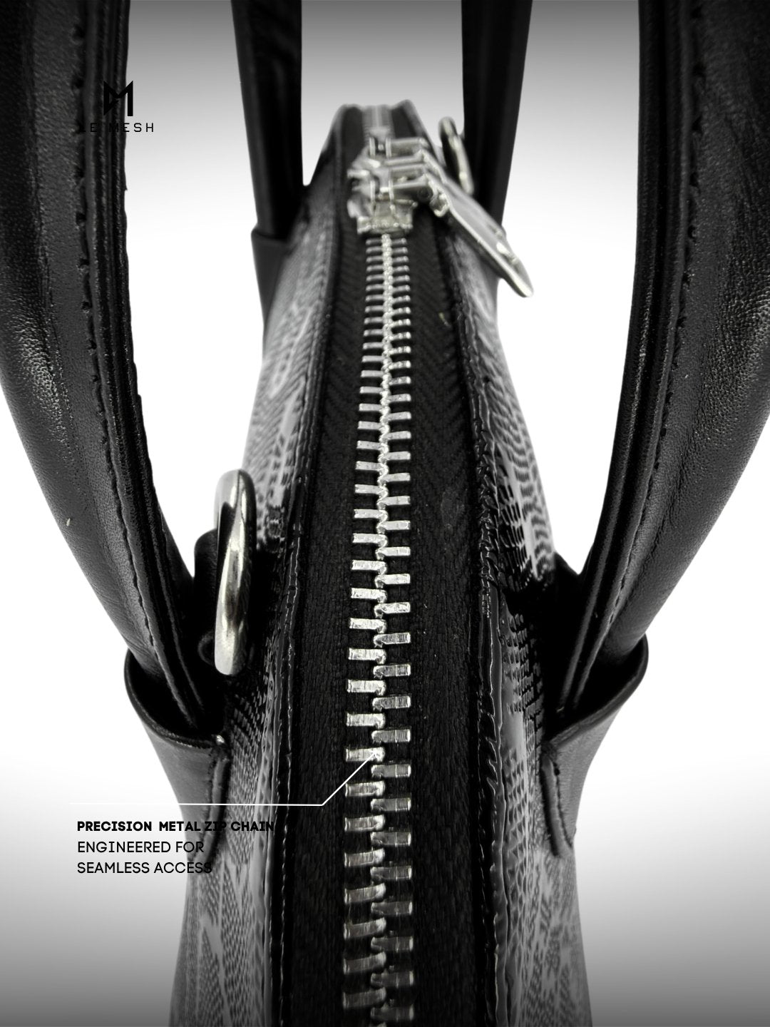Close-up of a black leather bag with a zipper, featuring precision metal components.
