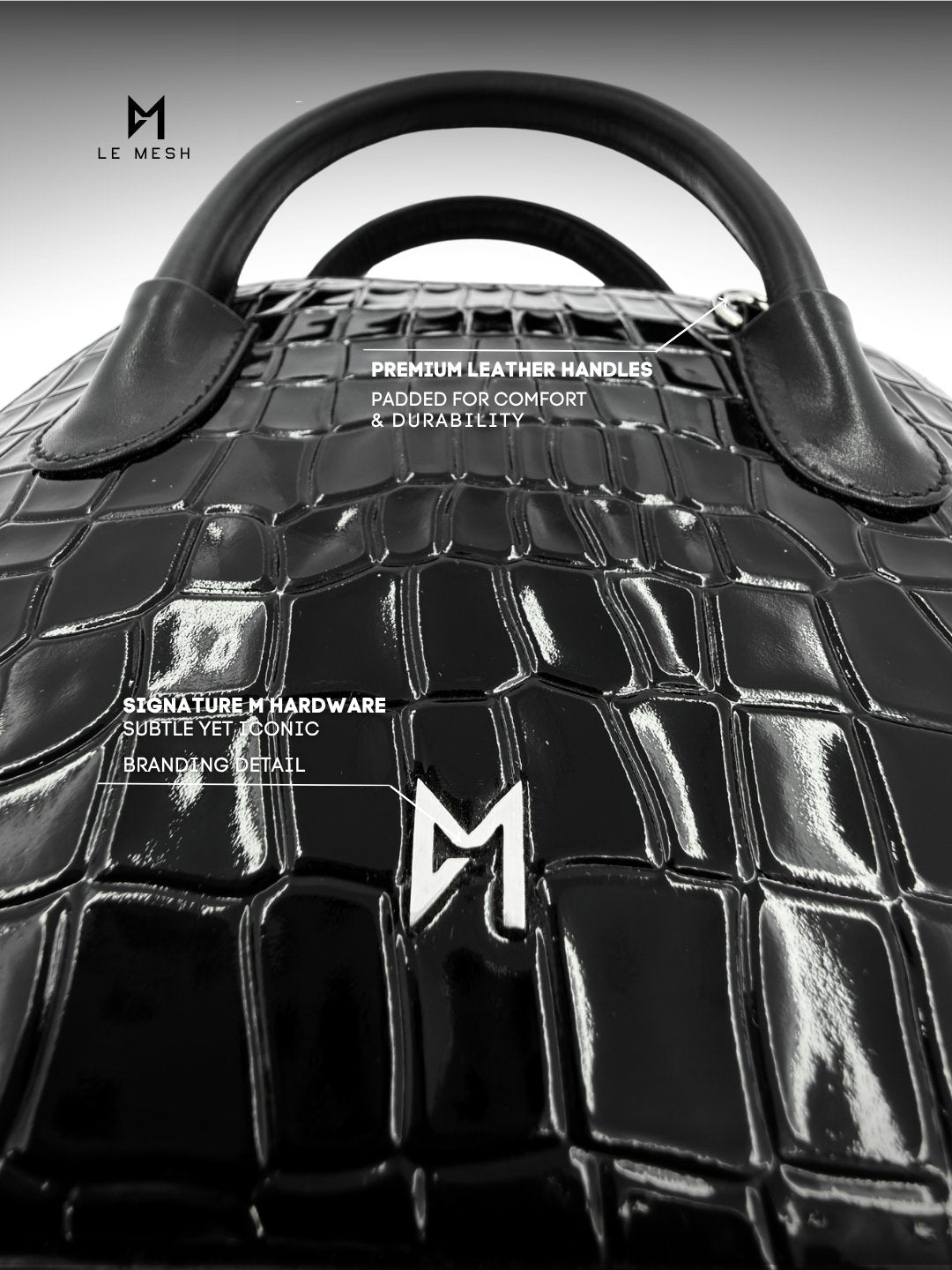 Black leather handbag with detailed text on handles and branding.
