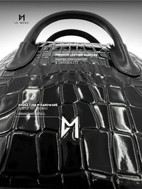 Black leather handbag with detailed text on handles and branding.