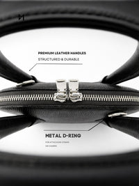 Black leather bag with metal D-ring and premium leather handles on a white background