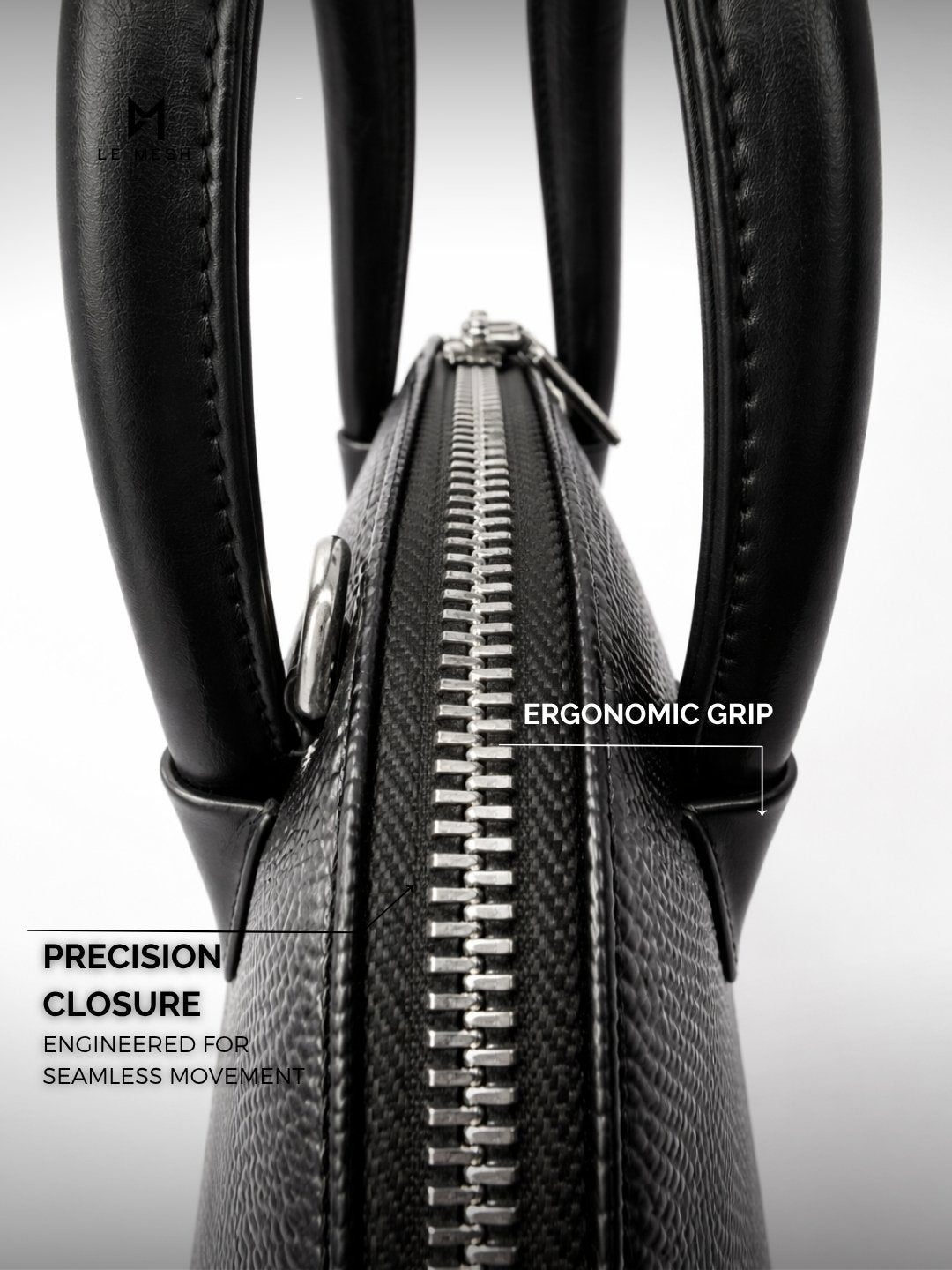 Black leather bag with ergonomic grip and precision closure on a light gray background