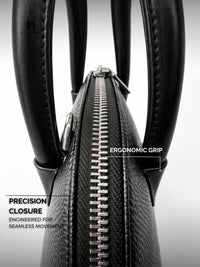 Black leather bag with ergonomic grip and precision closure on a light gray background