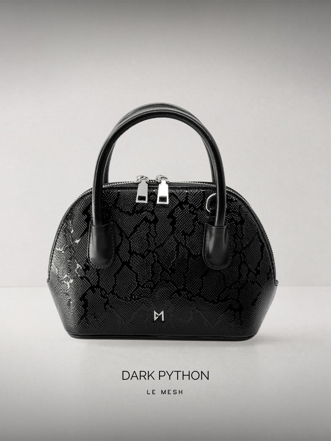 Black handbag with 'Dark Python' pattern on a light gray background
Black textured handbag with silver hardware on a light gray background