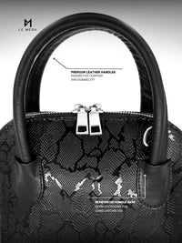 Black handbag with detailed text on leather handles and stitching quality.